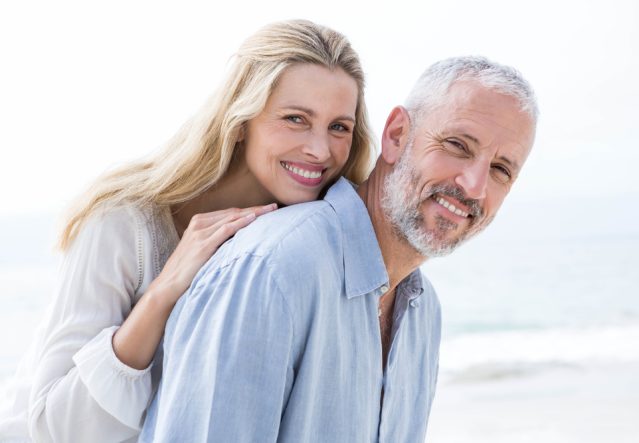 Happy,Couple,Hugging,Each,Other,And,Smiling,At,Camera,At