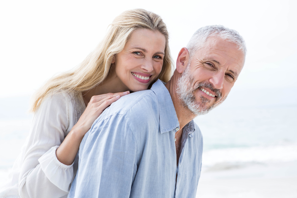 Happy,Couple,Hugging,Each,Other,And,Smiling,At,Camera,At